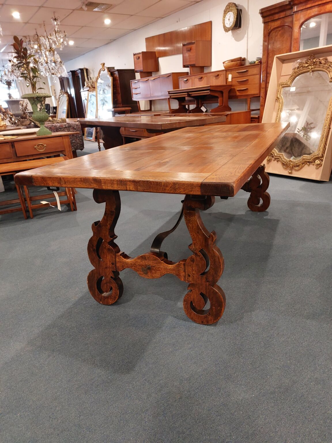 French Oak table with panels in top and iron form underneath. Table is in a Spanish style. Town and Country Antiques