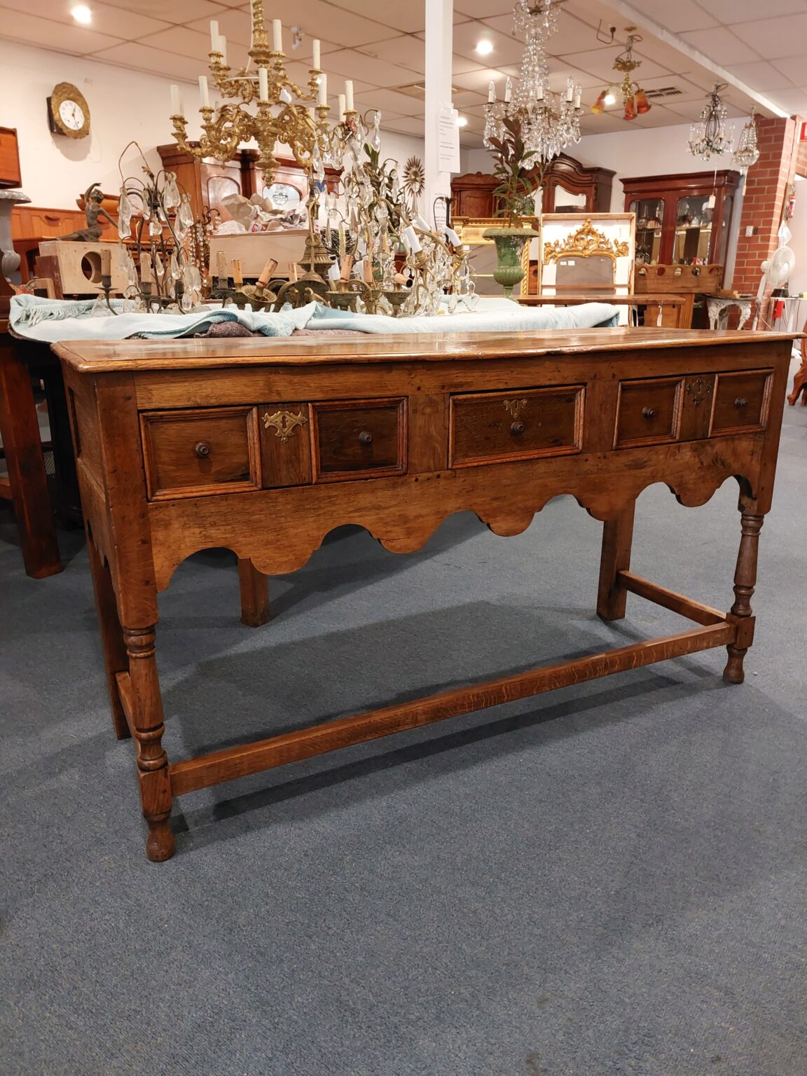English oak side table with 3 Drawers and scalloped apron. C:1750. Town and Country Antiques