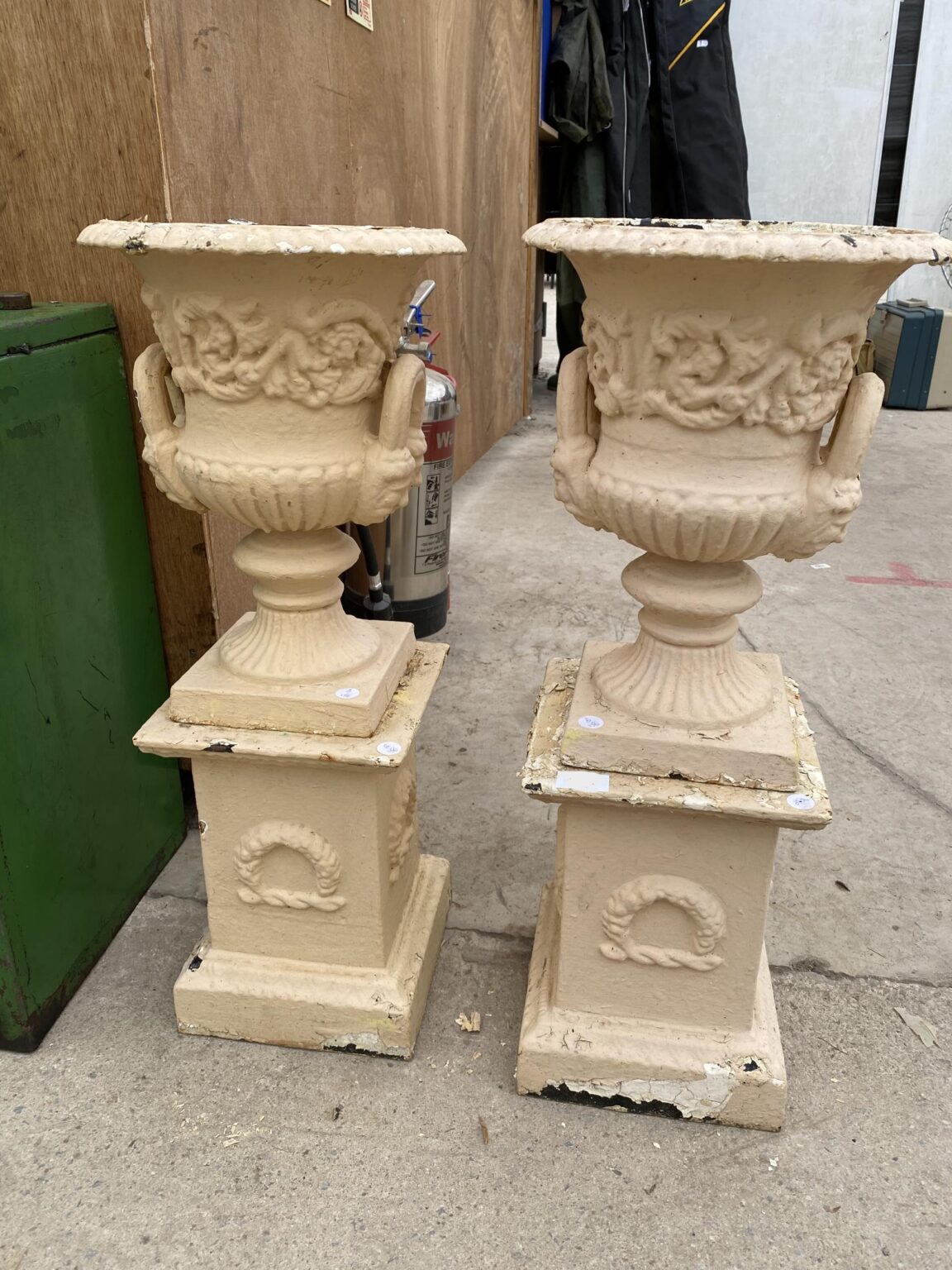 French cast Iron Urns on pedestals. Town and Country Antiques